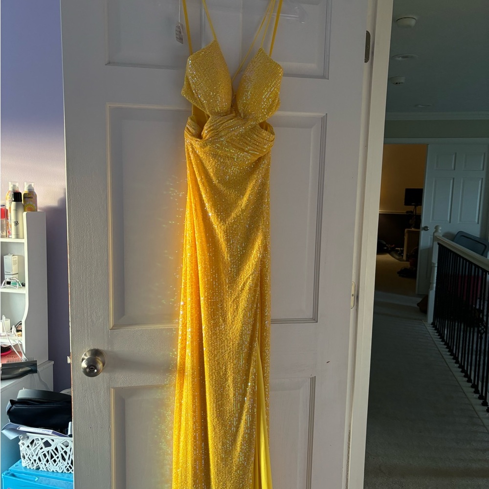 Brand new! Never altered or worn! Still has tags on! Yellow sequins formal gown!